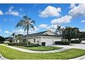 The house is a charming single-story residence with a well-maintained lawn, and a two-car garage at 1104 Auburn Cove Cir, Venice, FL 34292