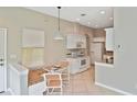 Eat-in kitchen showcasing modern appliances, a dining nook, and plenty of natural light at 1104 Auburn Cove Cir, Venice, FL 34292