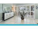 A stylish credenza sits in front of shuttered sliding doors, adding charm to the living space at 114 Southampton N Pl # 237, Venice, FL 34293