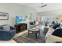 Bright and airy living room showcasing vaulted ceilings, tile flooring, and stylish decor at 114 Southampton N Pl # 237, Venice, FL 34293