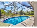 Sparkling pool enclosed in a screened lanai, perfect for outdoor relaxation and entertainment at 1214 Rumson Ct, North Port, FL 34288