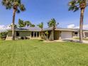 Well-maintained single-story home with an attached two-car garage and lush, green landscaping at 1240 Lucaya Ave, Venice, FL 34285