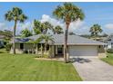 Charming single-story home featuring a well-manicured lawn and a convenient two-car garage at 1240 Lucaya Ave, Venice, FL 34285