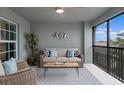 Serene covered patio with comfortable seating, modern decor, and a view of the outdoors at 12440 Wellen Golf St # 204, Venice, FL 34293