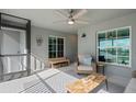 Inviting covered patio boasts a cozy chair, bench seating, and a stylish coffee table for relaxation at 12440 Wellen Golf St # 204, Venice, FL 34293