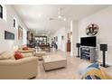 Bright, neutral living room with comfortable seating, tile floors, and an open floor plan at 13486 Nobilio St, Venice, FL 34293