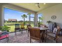 Enclosed patio with brick flooring, outdoor furniture, and views of the landscaped backyard at 13486 Nobilio St, Venice, FL 34293
