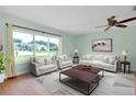 Bright living room featuring large windows and comfortable, neutral-toned furnishings at 18375 Lamont Ave, Port Charlotte, FL 33948