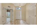 Bright foyer with tiled floor, transom window, and view into adjacent room at 201 Vestavia Dr, Venice, FL 34292