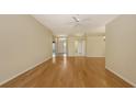 Open living area with hardwood floors, neutral walls, and ceiling fan at 201 Vestavia Dr, Venice, FL 34292