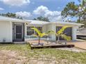 Inviting single-story home with a charming entrance and well-kept landscaping at 2020 E Crest Dr, Englewood, FL 34223