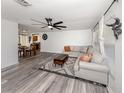 Spacious living room with modern gray flooring, ceiling fan, and comfortable seating at 2020 E Crest Dr, Englewood, FL 34223