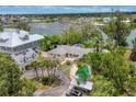 Aerial shot of a home featuring a sparkling pool, meticulous landscaping, and ample parking space in a serene neighborhood at 205 Louella Ln, Nokomis, FL 34275