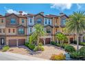 Beautiful townhouse exterior with brick driveway, stone accents, and mature palm trees at 209 E Venice Ave, Venice, FL 34285