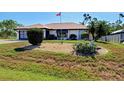Charming single-story home with a two-car garage, a well-kept lawn, and attractive landscaping at 2194 Abalom St, Punta Gorda, FL 33980