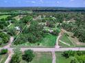 Expansive aerial view of a tree-lined property with a home, pool, and bordered outline at 27215 Crosby Rd, Myakka City, FL 34251
