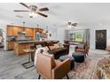 Open concept living room and kitchen featuring modern finishes, wood cabinets and island, and a fireplace at 27215 Crosby Rd, Myakka City, FL 34251