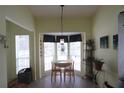 Charming dining area featuring a bay window, pendant lighting, and seating for two at 320 Clearbrook Cir # 203, Venice, FL 34292