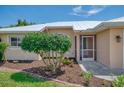 The cozy front entrance features a well-manicured garden and a sunny spot for plants at 331 Bucknell Rd, Venice, FL 34293