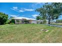 Charming home featuring a lush green lawn and a durable metal roof; a large shade tree is a bonus at 331 Bucknell Rd, Venice, FL 34293