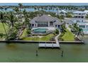 Back exterior with a pool and dock, ideal for waterfront living at 333 Sunrise Dr, Nokomis, FL 34275