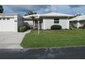 Charming single-story home with a well-manicured lawn, light grey paint, and white trim at 334 Dante Dr # 334, Nokomis, FL 34275