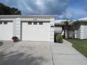 Attached garage with white door and trim plus a lush green lawn and exterior elevation at 334 Dante Dr # 334, Nokomis, FL 34275