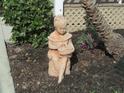 Charming yard decor with mulch and shrubs beside a palm tree in this garden setting at 334 Dante Dr # 334, Nokomis, FL 34275