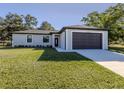 Beautiful single-Gathering home with two-car garage and well-kept lawn on a sunny day at 3588 Erie Ct, North Port, FL 34287