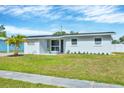 Inviting single-story home with fresh exterior paint, a green lawn, and tasteful landscaping for enhanced curb appeal at 3616 Lalani Blvd, Sarasota, FL 34232