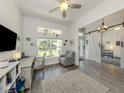 Inviting home office featuring wood-look floors, natural light, and a comfortable recliner at 460 Bard Rd, Venice, FL 34293