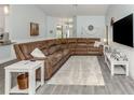 Spacious living room with a plush sectional sofa, wood-look floors, and coastal decor at 460 Bard Rd, Venice, FL 34293