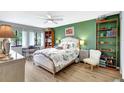 Cozy bedroom with hardwood floors, a ceiling fan, and a light-filled window view at 4646 Longwater Chase # 98, Sarasota, FL 34235