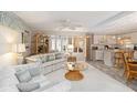 Bright living room featuring neutral décor, plush seating, and an open layout connected to the kitchen at 491 Cervina Dr, Venice, FL 34285
