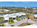 Aerial shot of single Gathering home with a well-manicured yard in a waterfront community at 608 Fair Winds Dr # 608, Nokomis, FL 34275