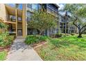 Condo building featuring well-maintained landscaping and inviting entry at 618 Bird Bay S Dr # 110, Venice, FL 34285