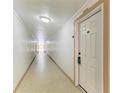 Hallway leading to unit with well-lit hallway at 618 Bird Bay S Dr # 110, Venice, FL 34285