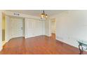 Spacious living room features hardwood floors and ample natural light at 618 Bird Bay S Dr # 110, Venice, FL 34285