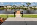 Waterfront home access featuring a private dock with easy access to the canal for boating and recreation at 700 Blackburn Blvd, North Port, FL 34287