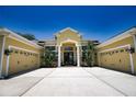 Charming home featuring a double garage and covered front entryway with pillars at 8209 Snowy Egret Pl, Bradenton, FL 34202