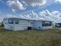Side view of a well-kept single-story home with a lush green lawn at 834 Cervina S Dr, Venice, FL 34285