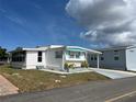 Attractive single-story home with a covered driveway and tidy landscaping at 834 Cervina S Dr, Venice, FL 34285
