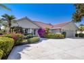 Attractive single-story home featuring a tile roof and beautifully landscaped front yard at 838 Carnoustie Dr, Venice, FL 34293