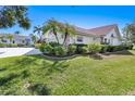 Attractive single-story home featuring a tile roof and manicured lawn at 838 Carnoustie Dr, Venice, FL 34293