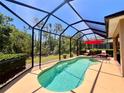 Inviting screened-in pool area features a sparkling pool and comfortable lounge seating, perfect for relaxation at 9118 Coachman Dr, Venice, FL 34293