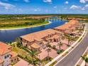 A waterfront community with long water views and red tile roofs and well-manicured landscaping at 10213 Staggerbush Dr # 202, Venice, FL 34293