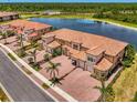 Aerial view of a multi-Gathering house, showcasing the well-maintained landscaping and idyllic waterfront location at 10213 Staggerbush Dr # 202, Venice, FL 34293