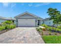 Beautiful one-story home with a brick driveway, two-car garage, and well-maintained landscaping at 10367 Abaco Falls Dr, Englewood, FL 34223