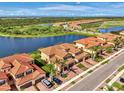 Beautiful aerial view of townhomes near water, golf course, and landscaping at 10789 Tarflower Dr # 202, Venice, FL 34293