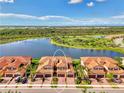 Lovely townhome features a tile roof, paver driveway, and water view at 10789 Tarflower Dr # 202, Venice, FL 34293